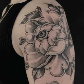 Black and grey tattoo of a peony flower with an eye ball in the center by IG @heidifureytattoo