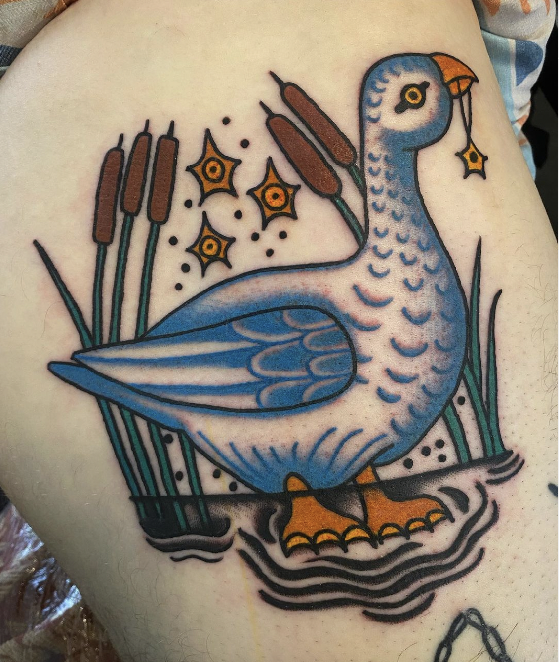 Blue, white, orange, green, and brown goose tattoo by IG @arietti.tattoo