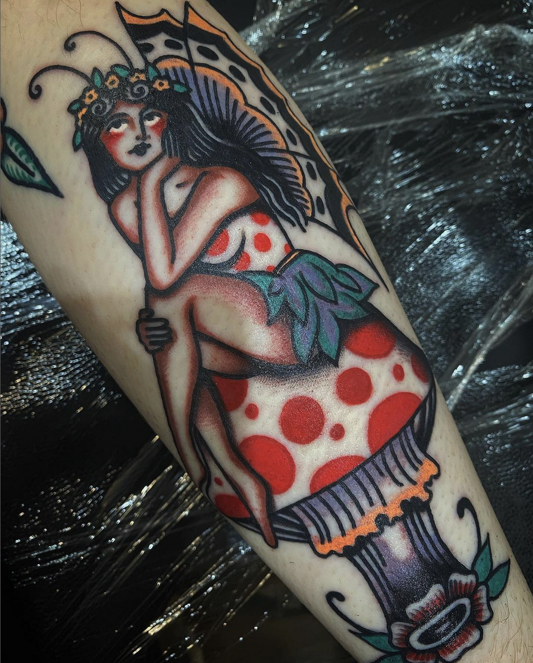 Pin-up fairy sitting on a mushroom tattoo by IG @arietti.tattoo