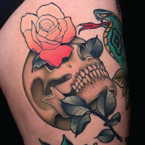 Neo traditional tattoo of a scull with an ombré pink and yellow rose growing out of the eye socket