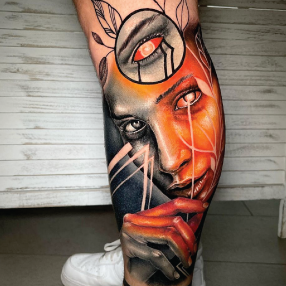 Black and orange realism portrait tattoo of a woman's face and hand