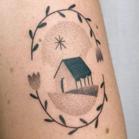Stick and poke tattoo of a house with two flowers surrounding it